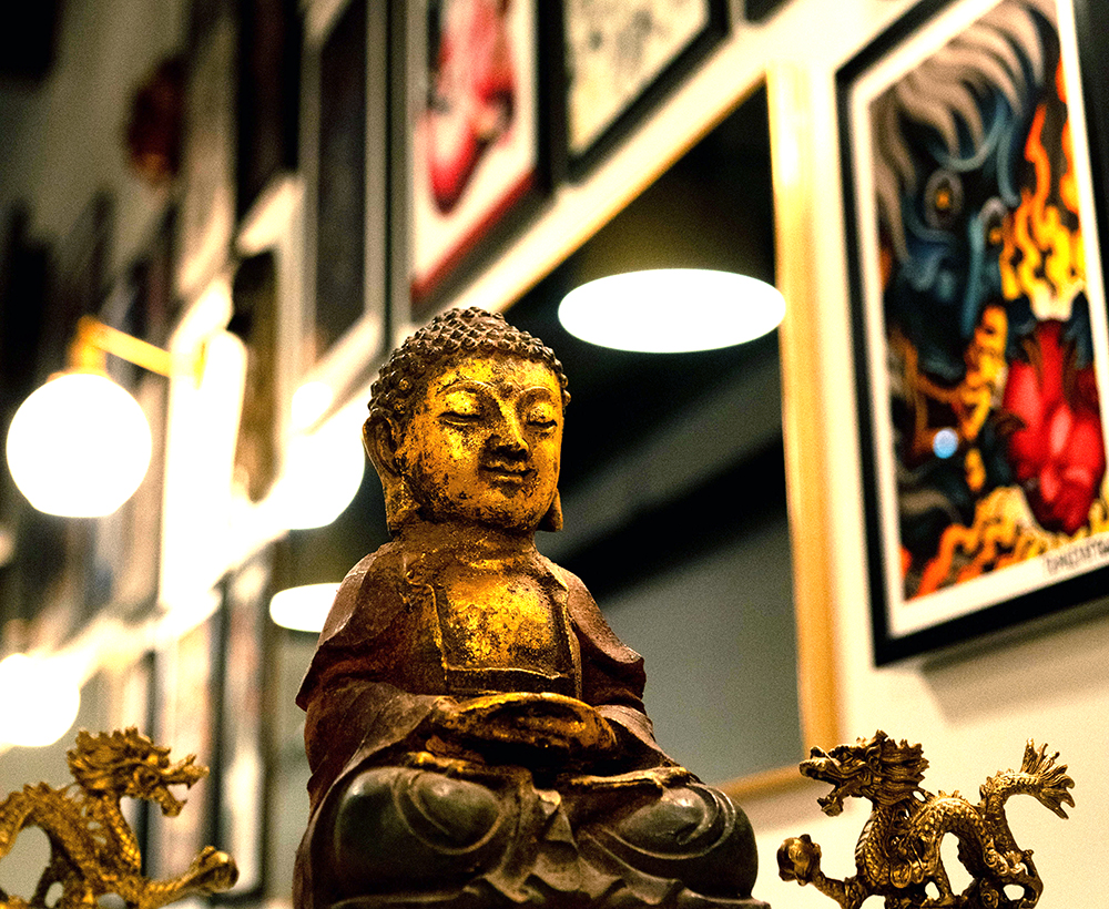 Golden Buddha statue at Oyabun Tattoo